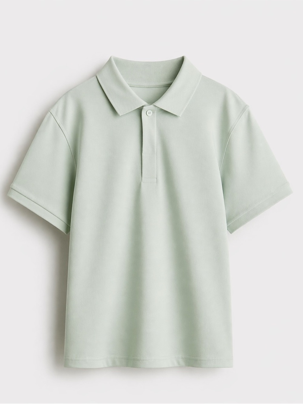 H&M Regular Fit Piqué polo shirt in a light sage green color.